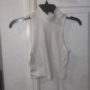 Turtle neck white sleeveless cropped shirt